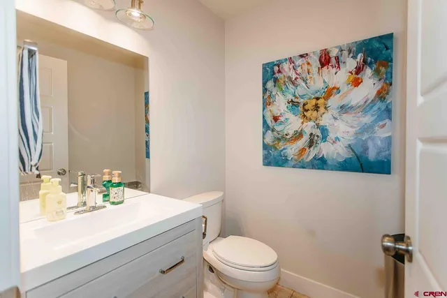 a bathroom with a toilet a sink and a mirror