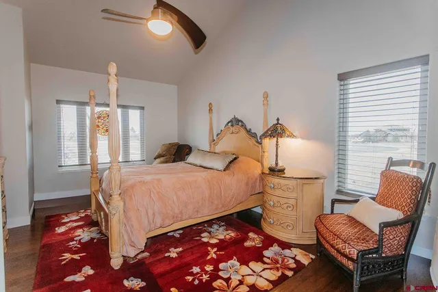 a bedroom with a bed chair and window