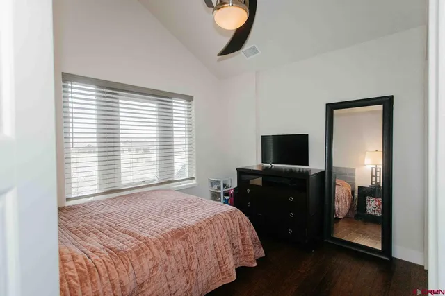 a bedroom with a bed and a television