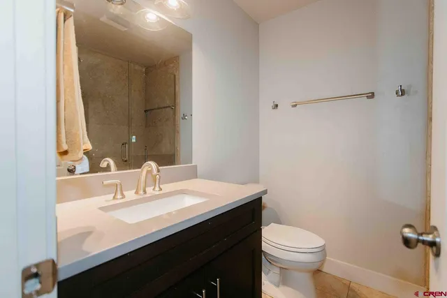 a bathroom with a sink a toilet and mirror