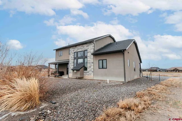 a view of a house with a yard and sitting area