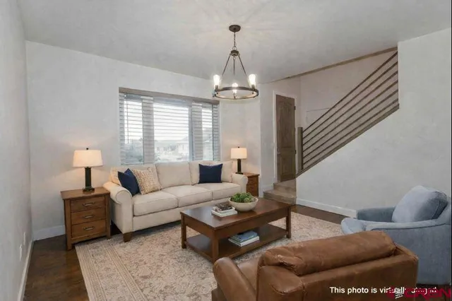 a living room with furniture and a chandelier