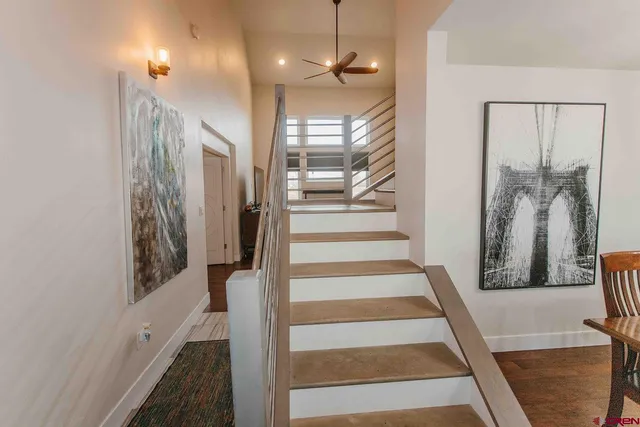 a view of a hallway with wooden floor and windows