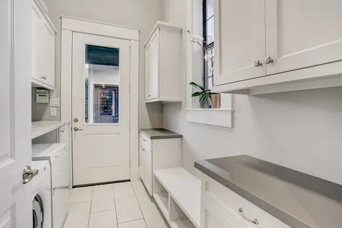 a kitchen with sink refrigerator and cabinets