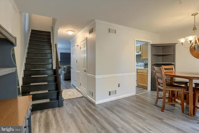 a view of a kitchen with furniture and wooden floor