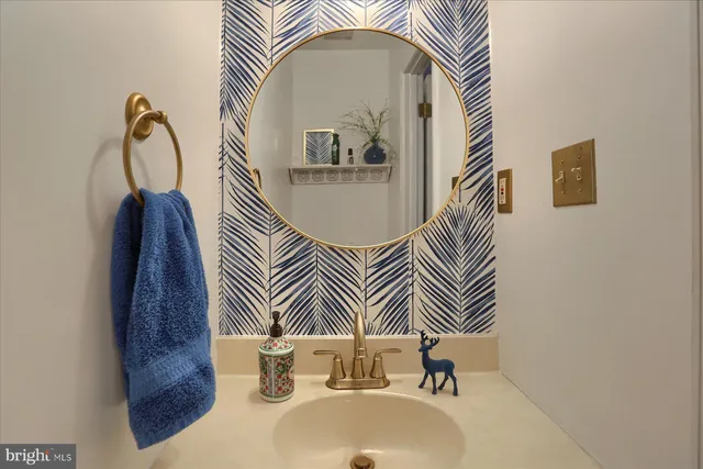 a bathroom with a sink a mirror and a toilet