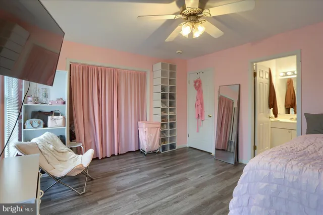 a view of a livingroom with wooden floor and an entryway