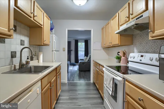 a kitchen with stainless steel appliances a sink and cabinets