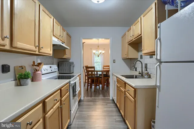 a kitchen with sink cabinets and stove