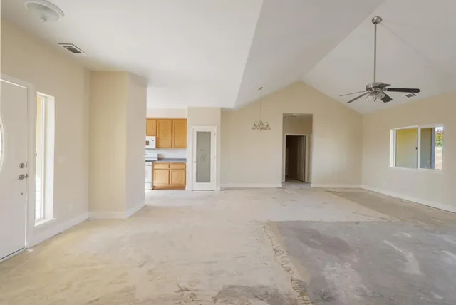a bathroom with a granite countertop toilet sink and mirror