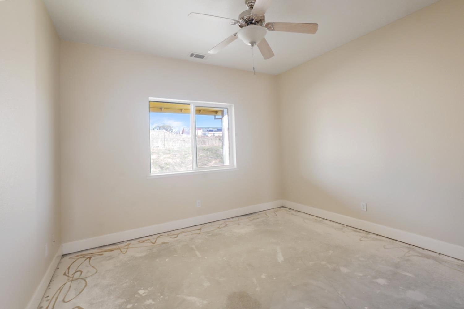 3493 Quail Hill Road Copperopolis, CA 95228 - Photo 18 of 38 an empty room with a window and a fan