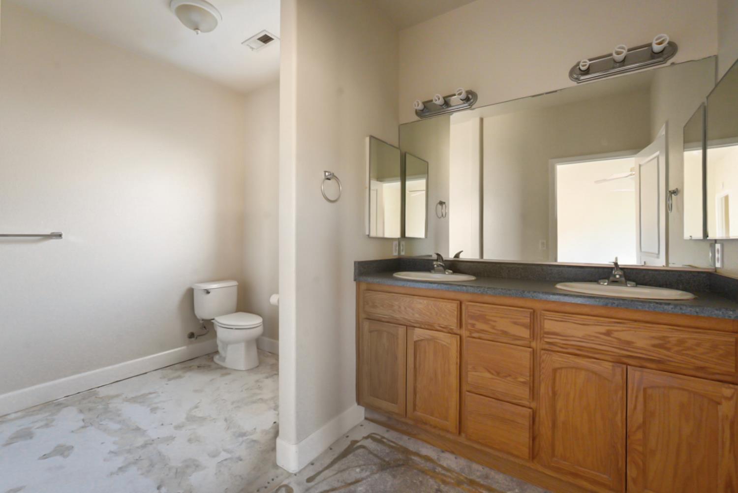 3493 Quail Hill Road Copperopolis, CA 95228 - Photo 23 of 38 a bathroom with a granite countertop sink mirror and toilet