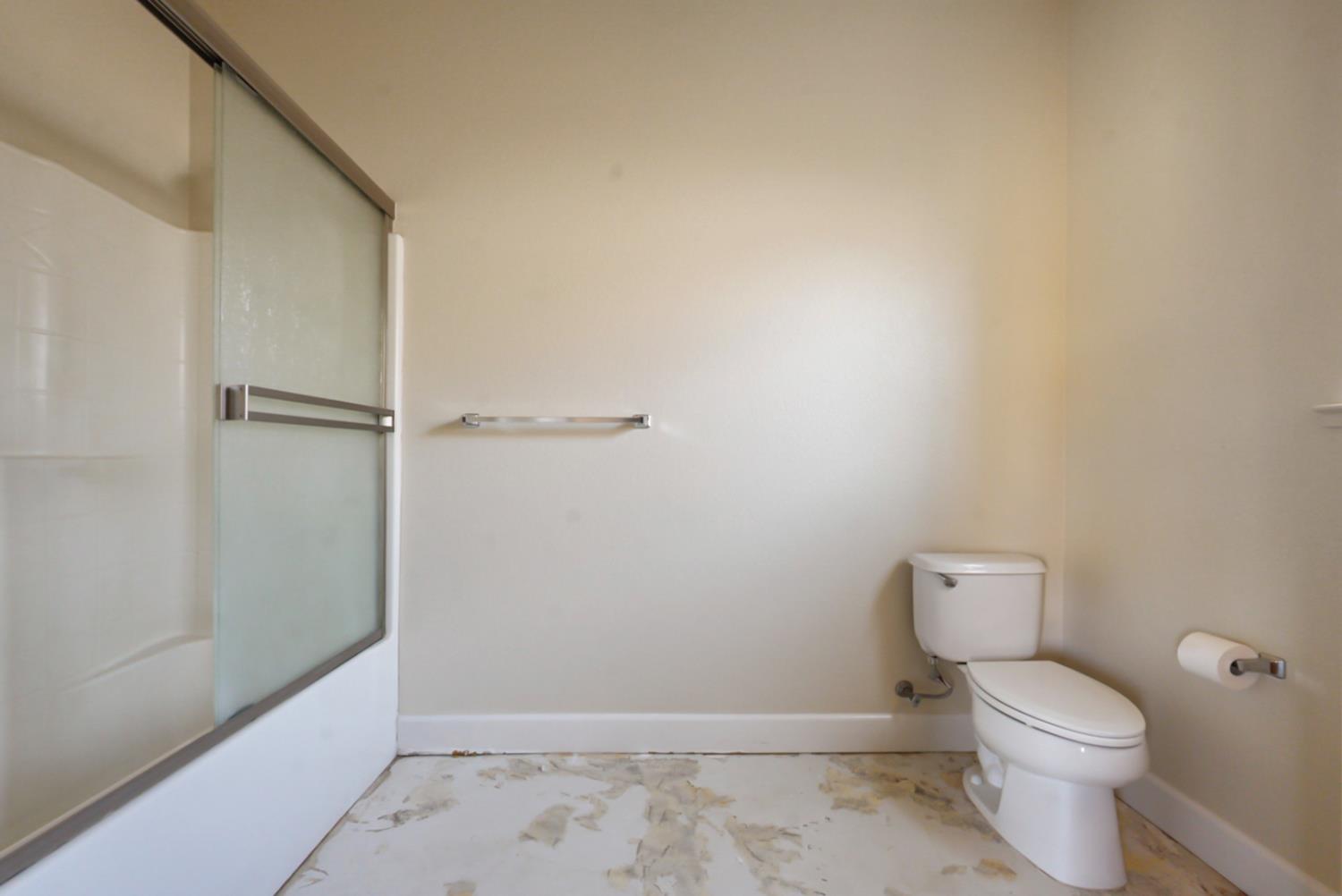 3493 Quail Hill Road Copperopolis, CA 95228 - Photo 24 of 38 a white toilet sitting next to a shower