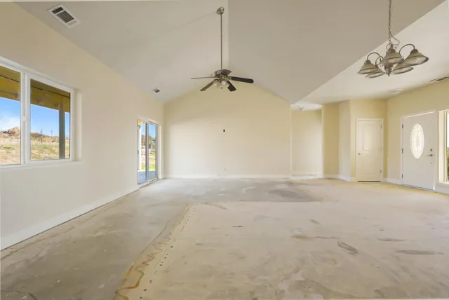 an empty room with a empty space and windows