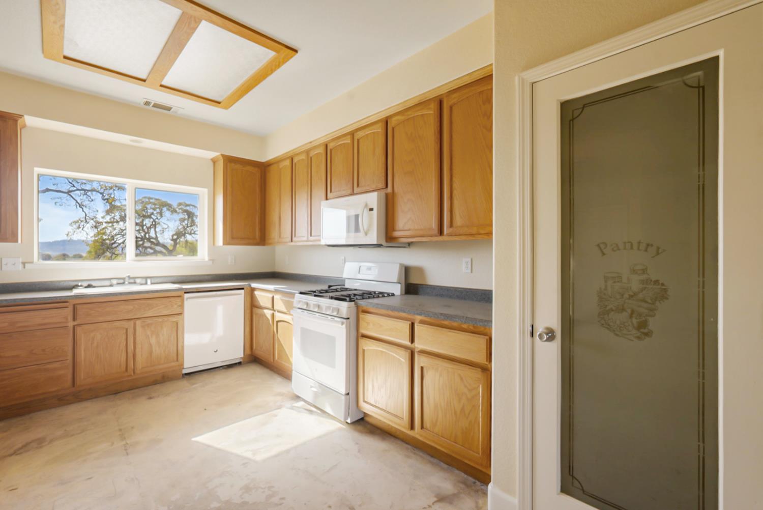 3493 Quail Hill Road Copperopolis, CA 95228 - Photo 28 of 38 a large kitchen with cabinets and wooden floor