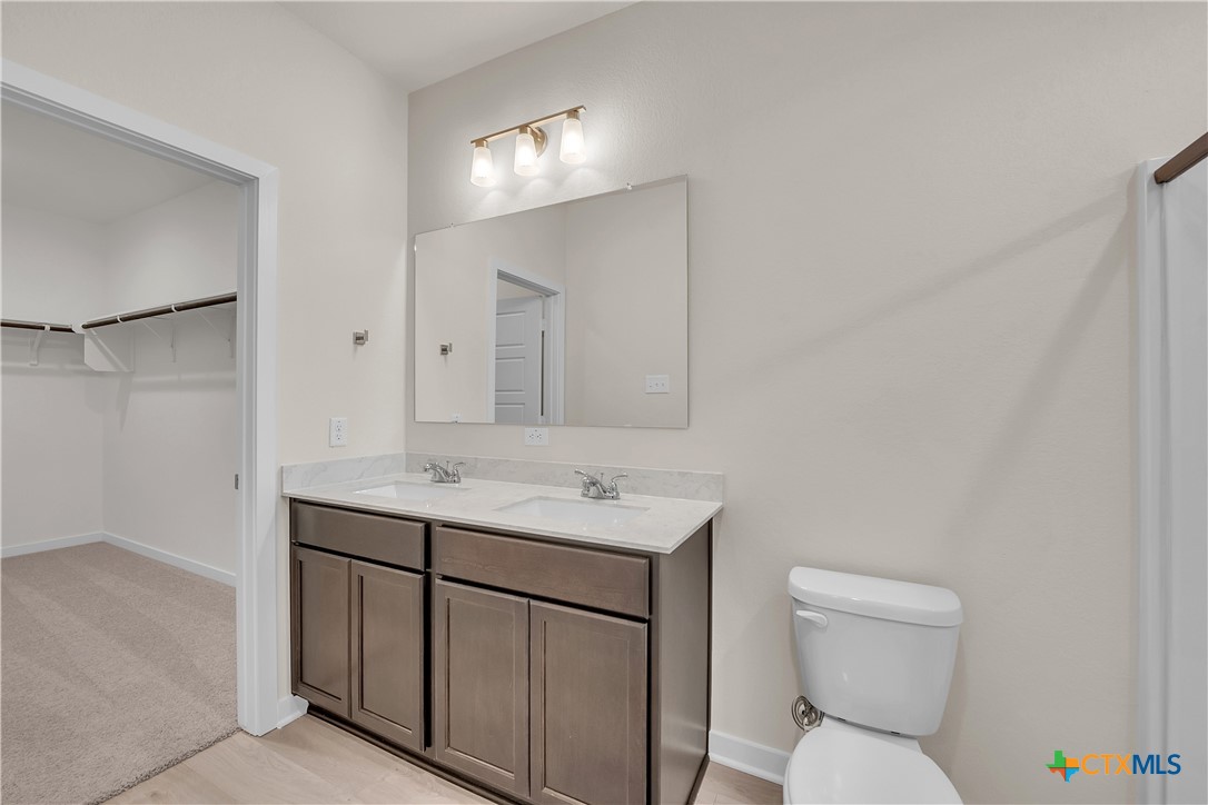 417 University Avenue Troy, TX 76579 - Photo 13 of 30 a bathroom with a toilet a sink and mirror