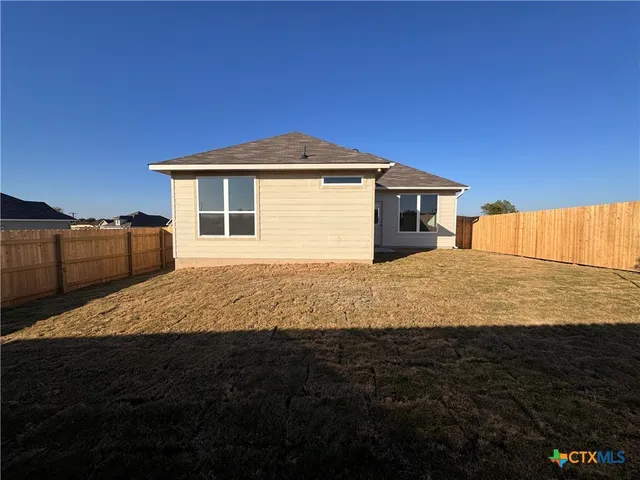 a yard with wooden fence