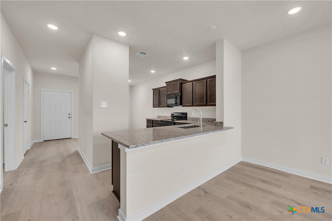 417 University Avenue Troy, TX 76579 - Photo 21 of 30 a kitchen with a sink stainless steel appliances and cabinets
