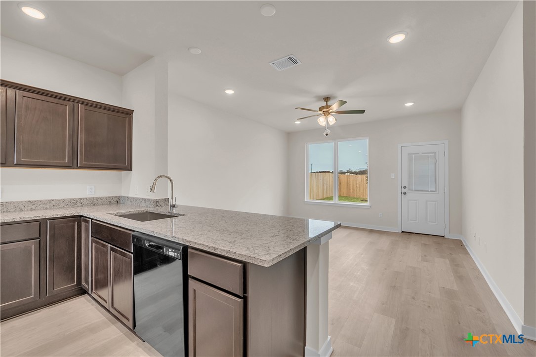 417 University Avenue Troy, TX 76579 - Photo 23 of 30 a kitchen with a sink chandelier and stove