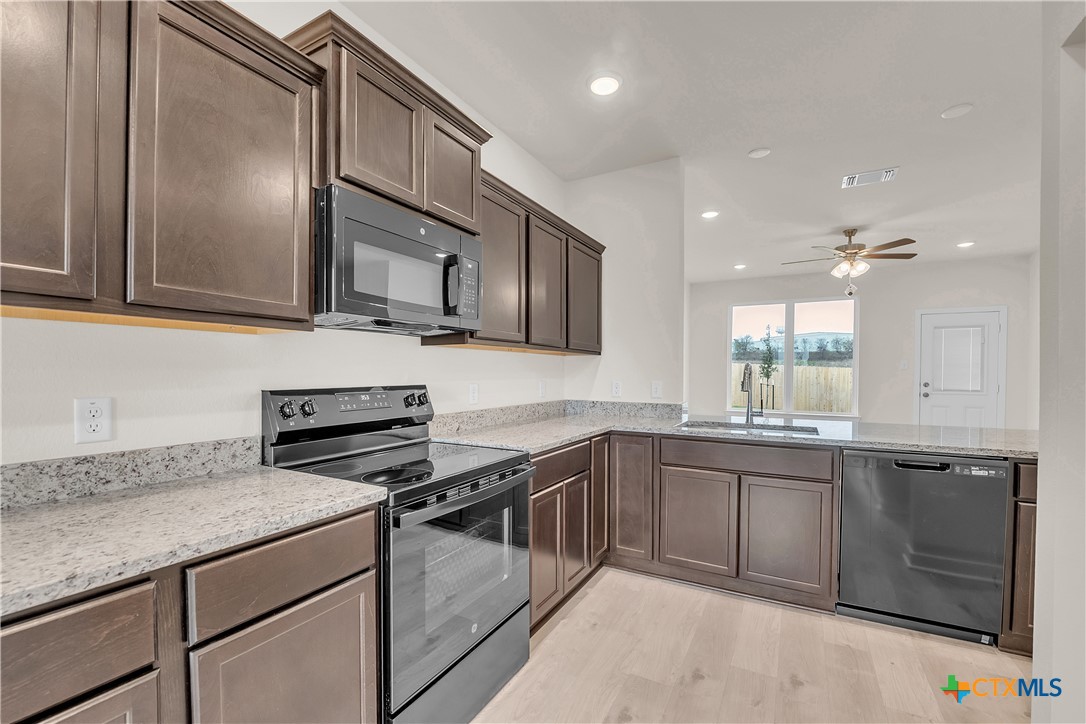 417 University Avenue Troy, TX 76579 - Photo 27 of 30 a kitchen with stainless steel appliances granite countertop a sink stove and cabinets
