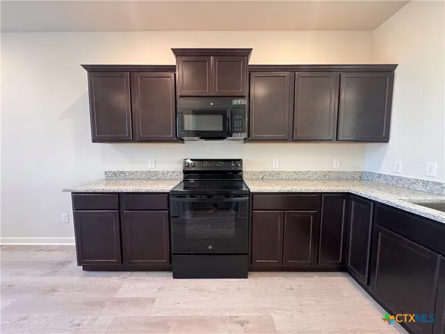 a kitchen with a refrigerator and a sink