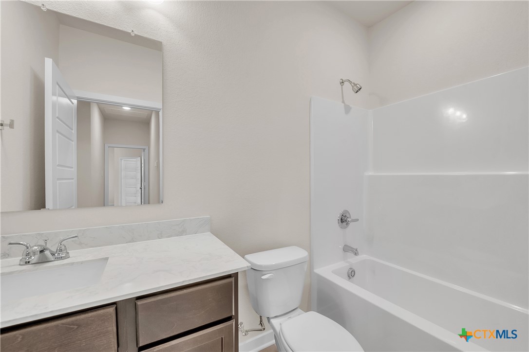 417 University Avenue Troy, TX 76579 - Photo 7 of 30 a bathroom with a sink toilet vanity and bathtub