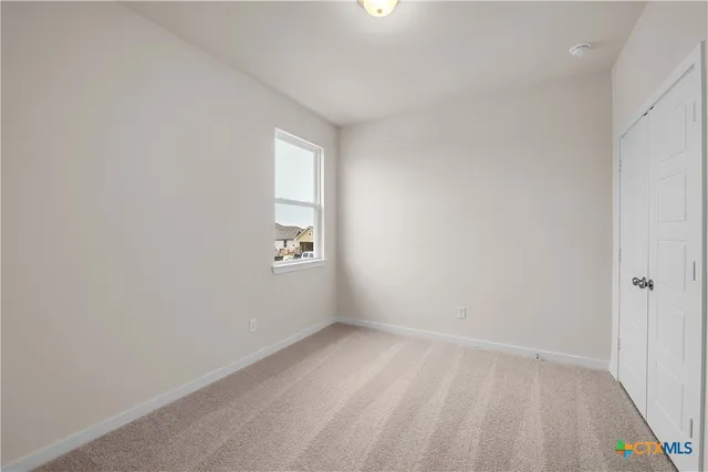 a view of an empty room and a window