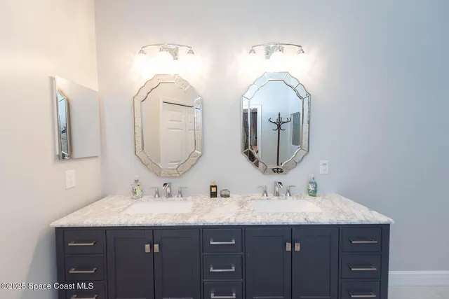 a bathroom with a sink double vanity and a mirror