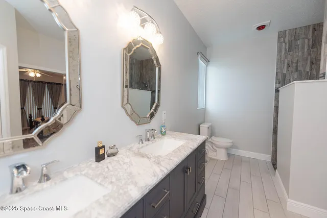 a bedroom with a bed a dresser and flat screen tv