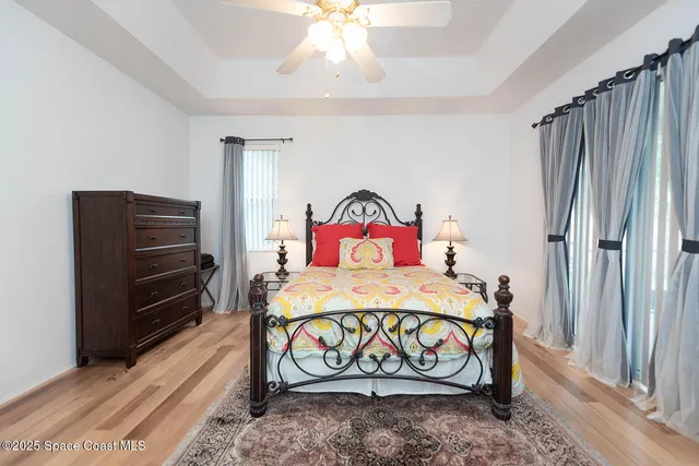 a bedroom with a bed next to a window with outer view