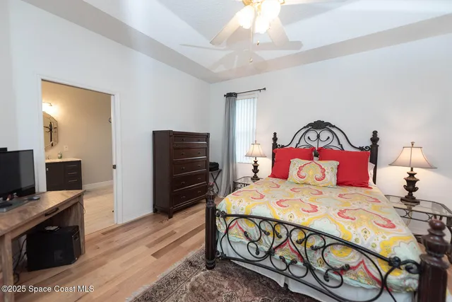 a bedroom with a bed and a television