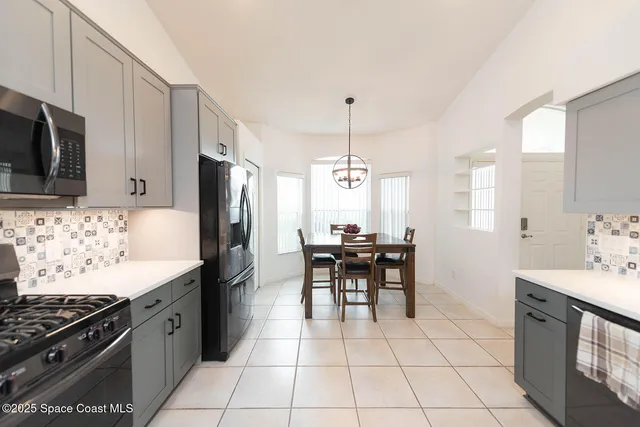 a kitchen with cabinets stainless steel appliances and a counter space