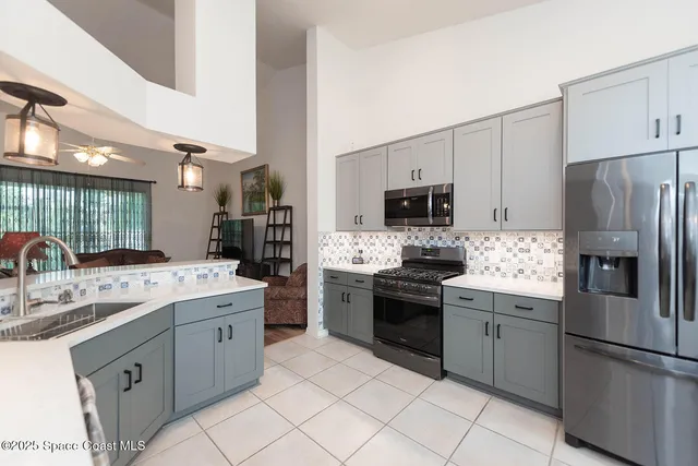 a kitchen with cabinets and steel stainless steel appliances