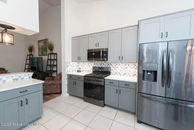 a large white kitchen with cabinets