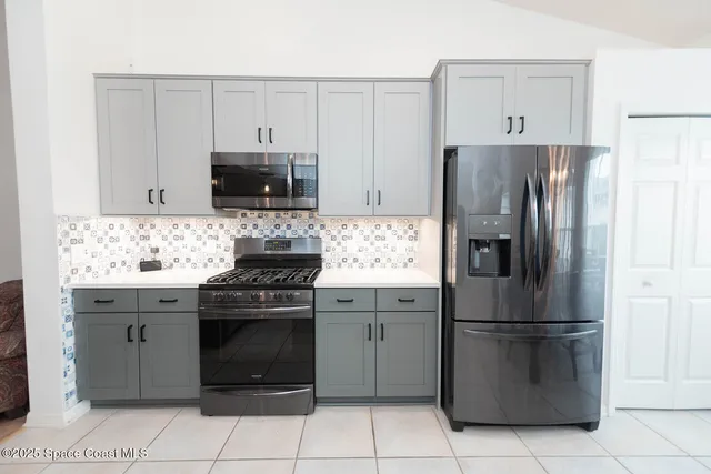 a spacious bathroom with a granite countertop sink and a large mirror