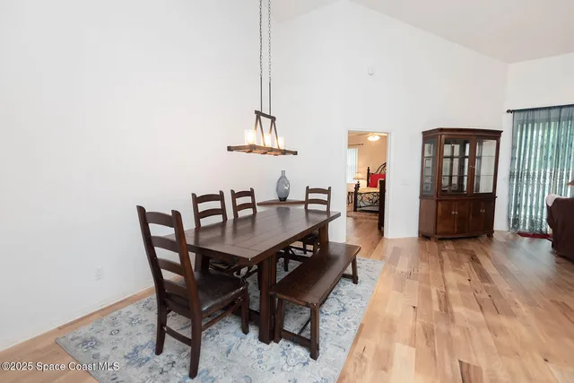a kitchen with stainless steel appliances a sink cabinets and wooden floor