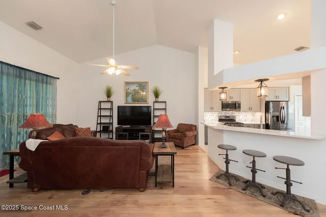 a view of a kitchen with wooden floor and chair