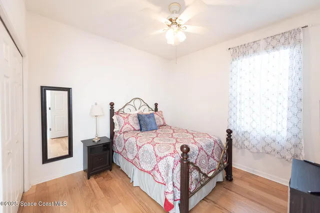 a bedroom with a bed and a mirror