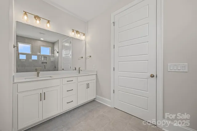 a spacious bathroom with a granite countertop sink and a mirror