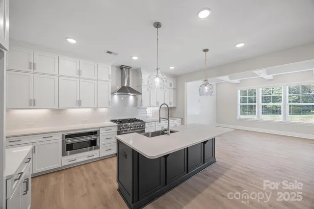 a kitchen with a sink stove and cabinets