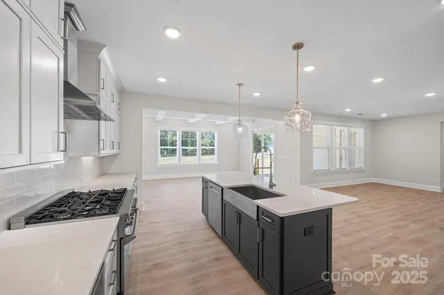 a kitchen with a sink stove and wooden cabinets
