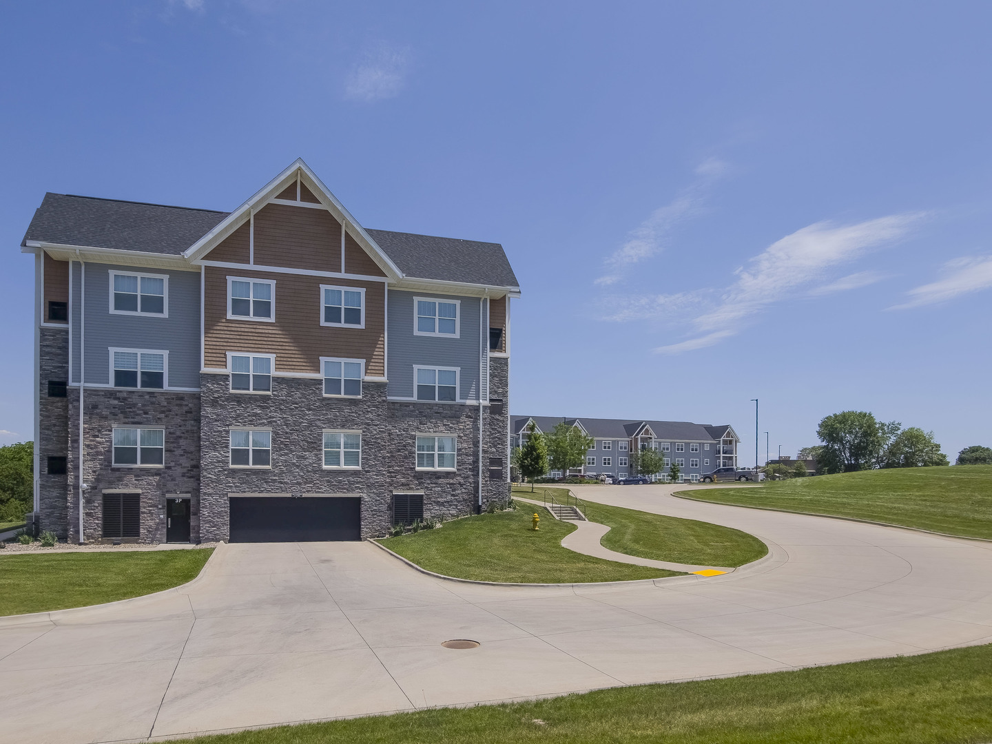2592 Middle Road, Unit 313 Bettendorf, IA 52722 - Photo 49 of 52 a front view of a house with a yard and garage