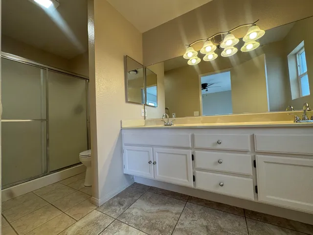 a bathroom with a sink vanity and a mirror