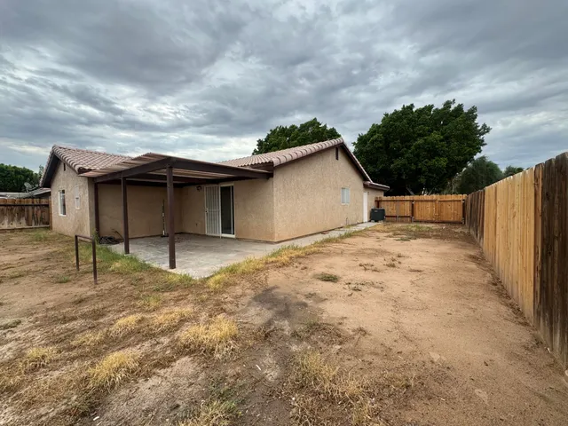 a white house with tree in the background