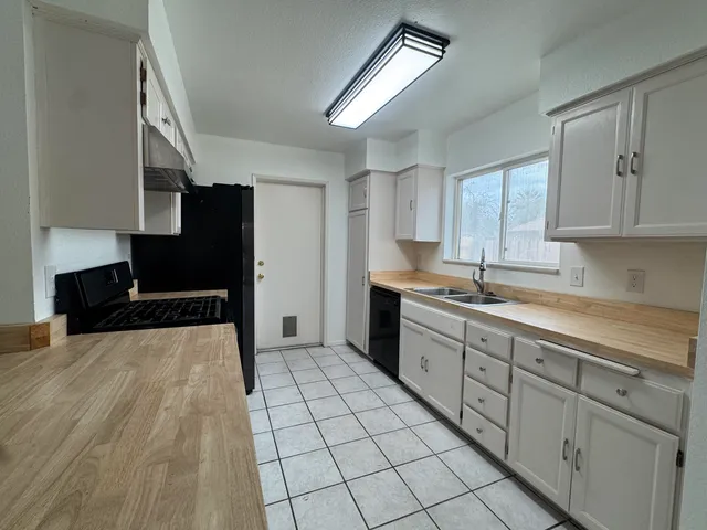 a kitchen with stainless steel appliances a stove a sink and a refrigerator