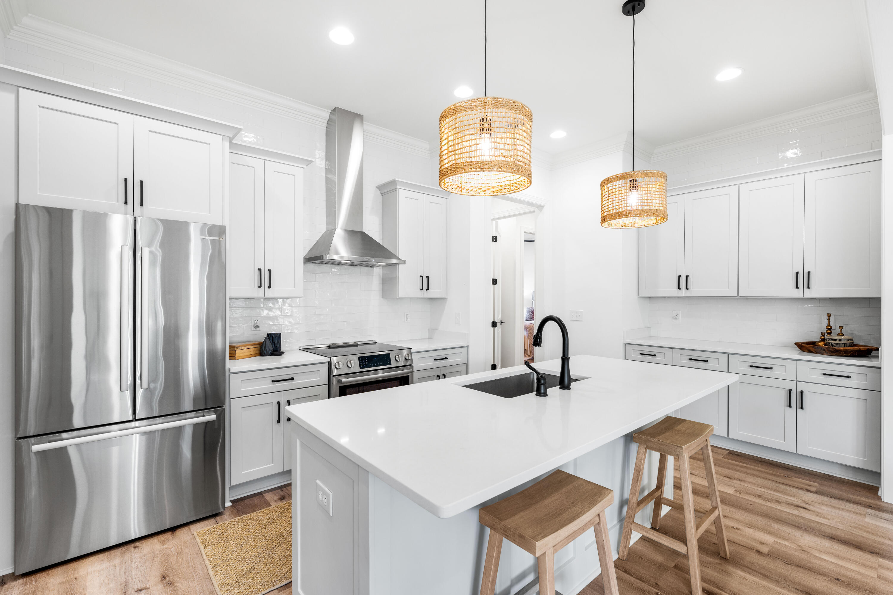 59 Suwannee Dr Inlet Beach Inlet Beach, FL 32461 - Photo 23 of 47 a kitchen with stainless steel appliances granite countertop a sink a stove a refrigerator cabinets a dining table and chairs with wooden floor