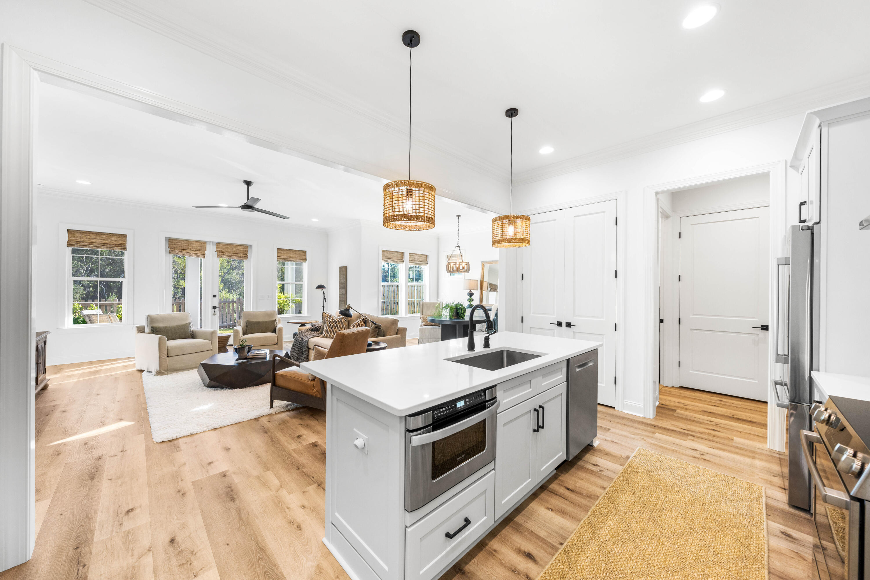 59 Suwannee Dr Inlet Beach Inlet Beach, FL 32461 - Photo 25 of 47 a view of a kitchen with kitchen island a large counter top space a sink stainless steel appliances and a chandelier
