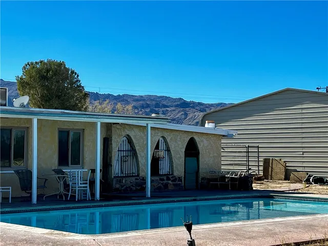 a bed room with two beds and a chair