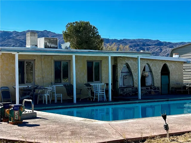 a living room with furniture a flat screen tv and a window