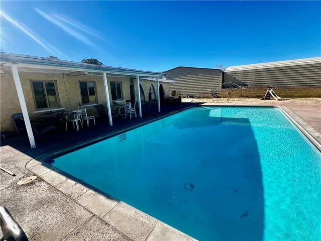 a backyard of a house with table and chairs